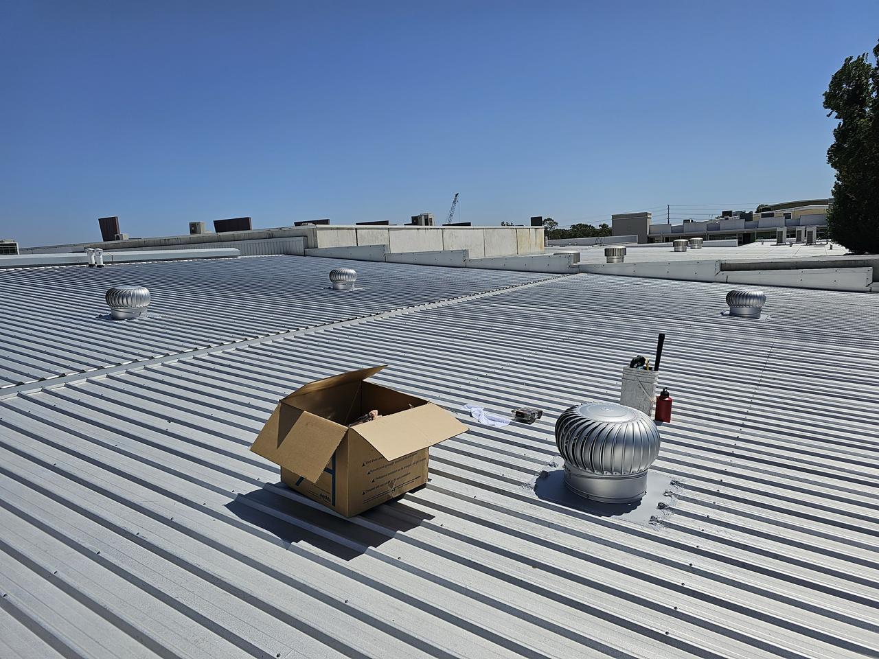 New commercial Colorbond metal roof with whirlybird vents installed by GRM